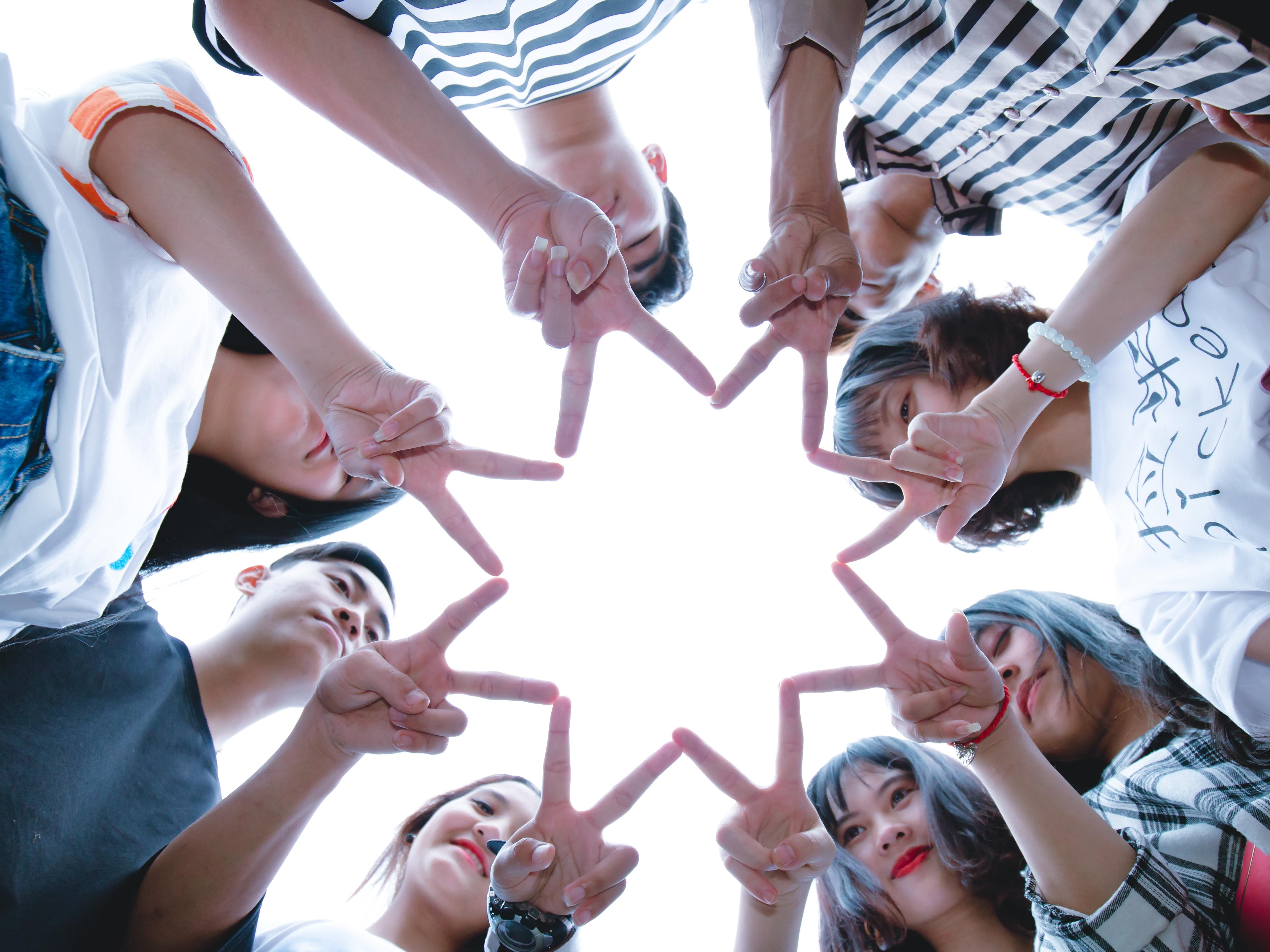 Teens making star shape with fingers